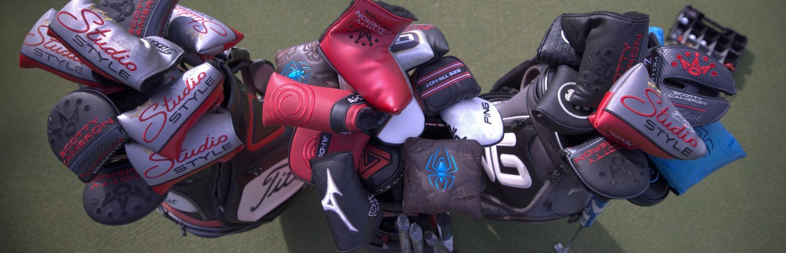 Putters with headcovers from Scotty Cameron, Odyssey, PING and TaylorMade in tour bags