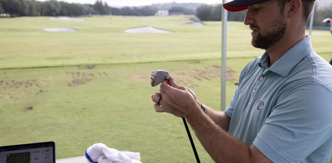 A Next Gear fitter checking launch numbers on the laptop during a fitting at Barton Creek